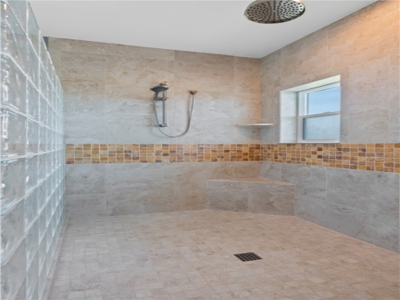 Large walk-in shower with handheld showerhead and rainfall showerhead