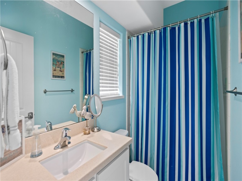 Bunk Room Bathroom is just inside the backyard door for easy access to yard and pool.