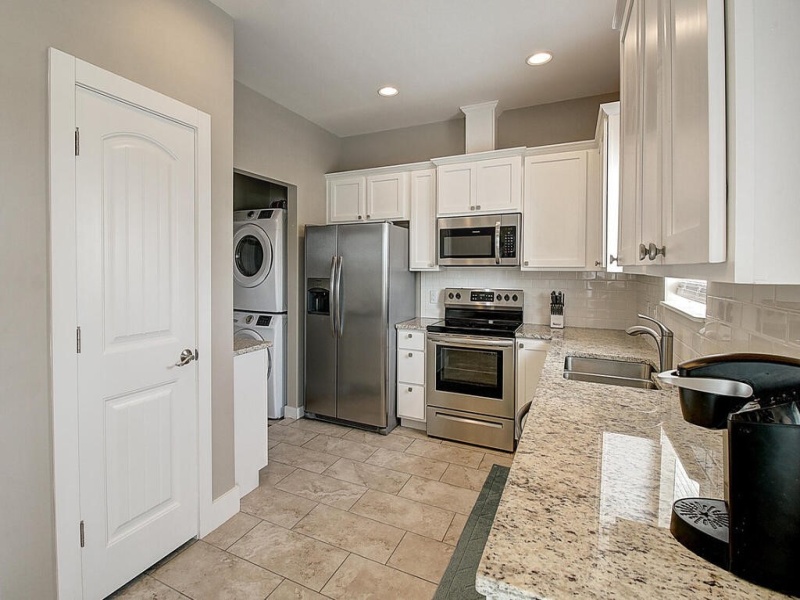 Step saver kitchen with pantry and laundry area.