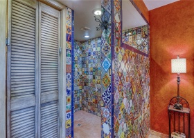 Large walk-in shower boasts hand painted  tiles!