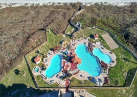 Resort pool area with 3 pools, 1 heated, spa and sand volleyball court with boardwalk crossover to the beach.