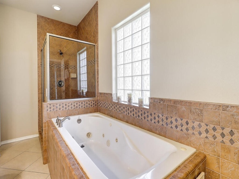 Downstairs master bath with jacuzzi tub and shower.