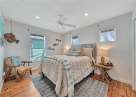 This upstairs bedroom is also roomy with space for a king bed
