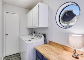 Big laundry room with folding counter and new washer and dryer.