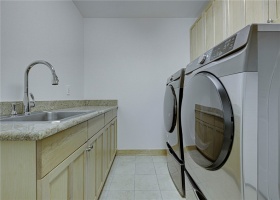 Laundry Room with Built In cabinet & sink