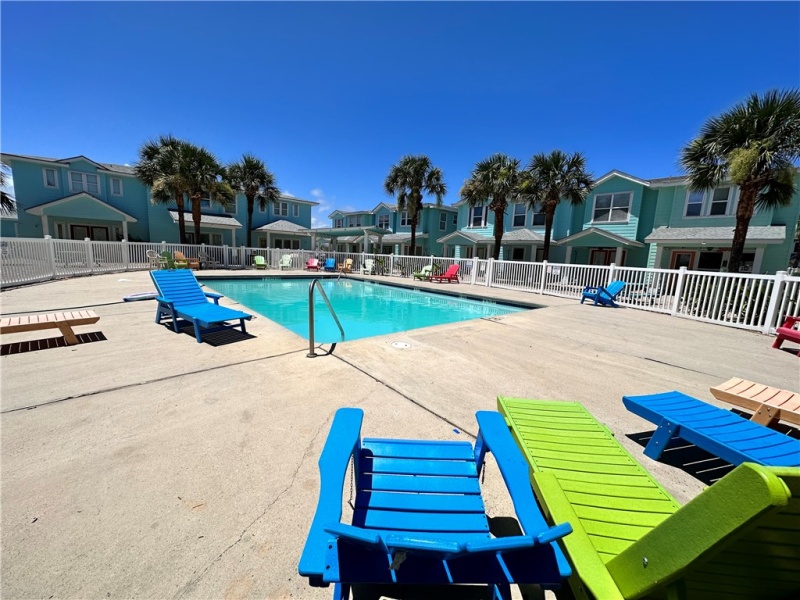 Community pool area with chairs