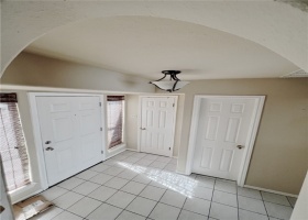 View of entry space. There is a closet and guest bathroom at entry.