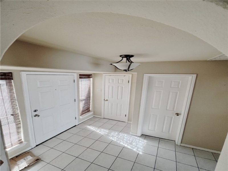 View of entry space. There is a closet and guest bathroom at entry.