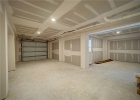 One car garage with additional storage/workshop space.