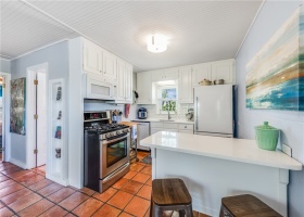 Kitchen with views of the original St Catholic Church, antique buffet with quartz countertop, brand new refrigerator & dishwasher