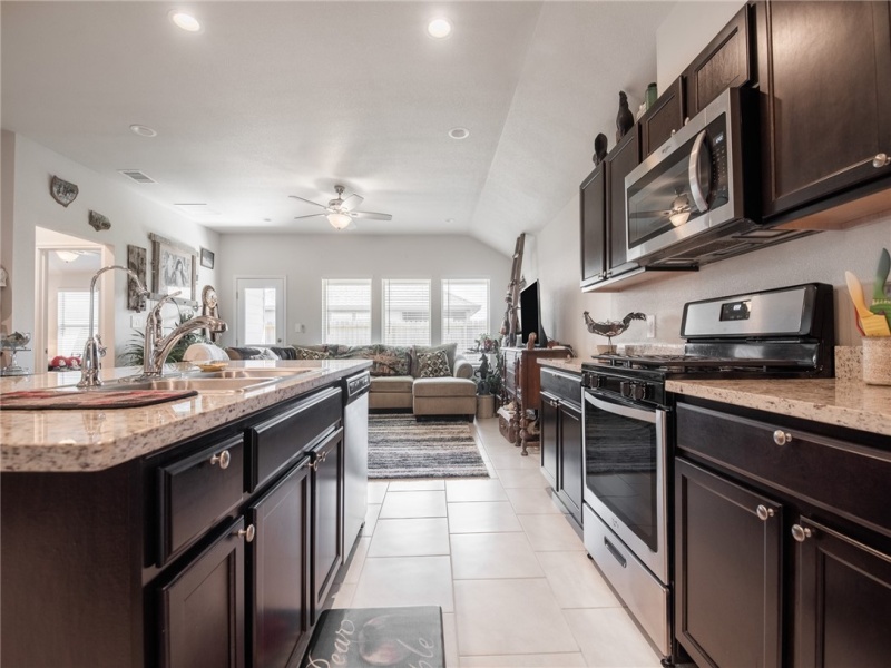 Kitchen with large island and stainless steel appliances.