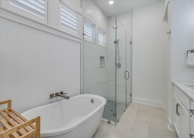 Ground level primary suite bath tub/shower side.