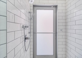 Access to outdoor shower through interior shower
