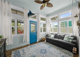 Enclosed sunroom and door to outside deck and patio.  Sunroom has central a/c