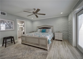 Beautiful bedroom with soft coastal colors. Private patio off bedroom.