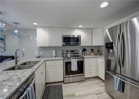 The kitchen is beautiful with light color tones & stainless appliances.