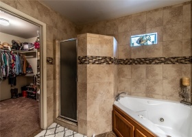 Main bathroom with standup shower and jet tub