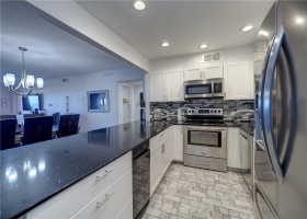 Stainless appliances with Quartz countertops. You even have a trash compactor for a space saver.