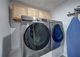 Laundry room with raised washer and dryer.