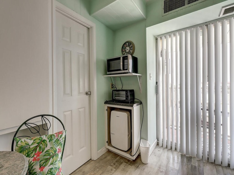 Originally a coffee nook, most have preferred the micro/toaster use.  Below is a dehumidifier with drain connected to plumbing drain.  Door opens to closet / bath