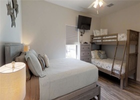 Second downstairs bedroom with queen bed and a twin over full size bunk.