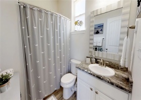 Full upstairs bath with single sink and shower.