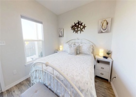 Downstairs Bedroom with king size bed, attached full bath and private access to fenced outdoor patio.