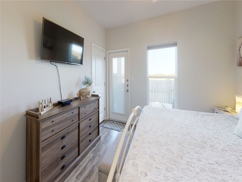 Downstairs bedroom with private access to fenced outdoor patio.