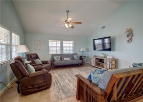 Large living room offers plenty of seating for everyone. You will love the vaulted ceilings.