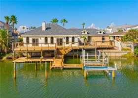 Enjoy your peaceful view from back of the home. Dock, expansive multi-level decks, covered breezeway connects main house from bunk room/guest house/3rd car garage