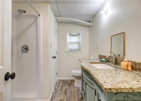 Downstairs bath with granite counters and shower.
