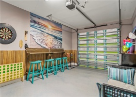 What a fun space! Open the garage door for the ocean breeze and play darts and games with friends.