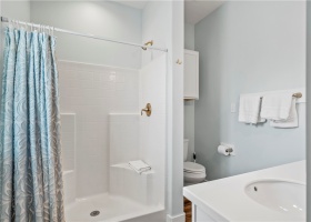 The primary bathroom is spacious and features double sinks.