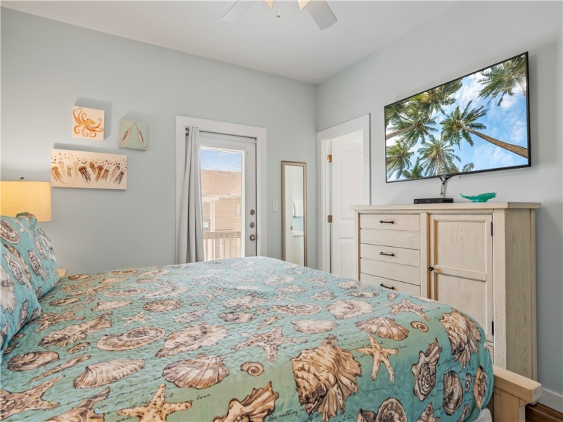 The primary bedroom is on the 2nd level and features a king-sized bed and beautiful furniture. This bedroom has access to a private front patio.