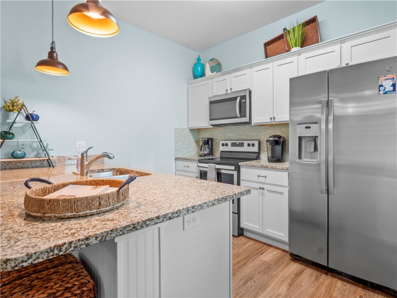 The upgraded kitchen has new backsplash tile and paint with new fixtures. Refrigerator included.