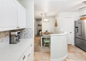 Kitchen features stainless steel appliances, quartz countertops and walk in pantry.